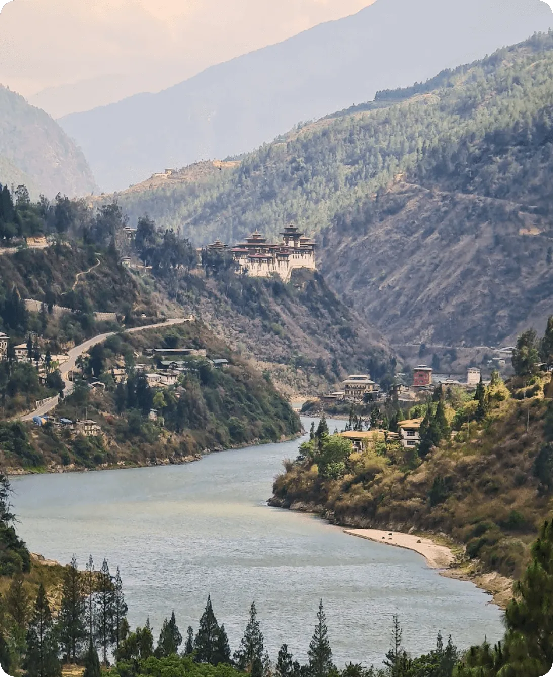 Majestic mountains surround flowing river in valley